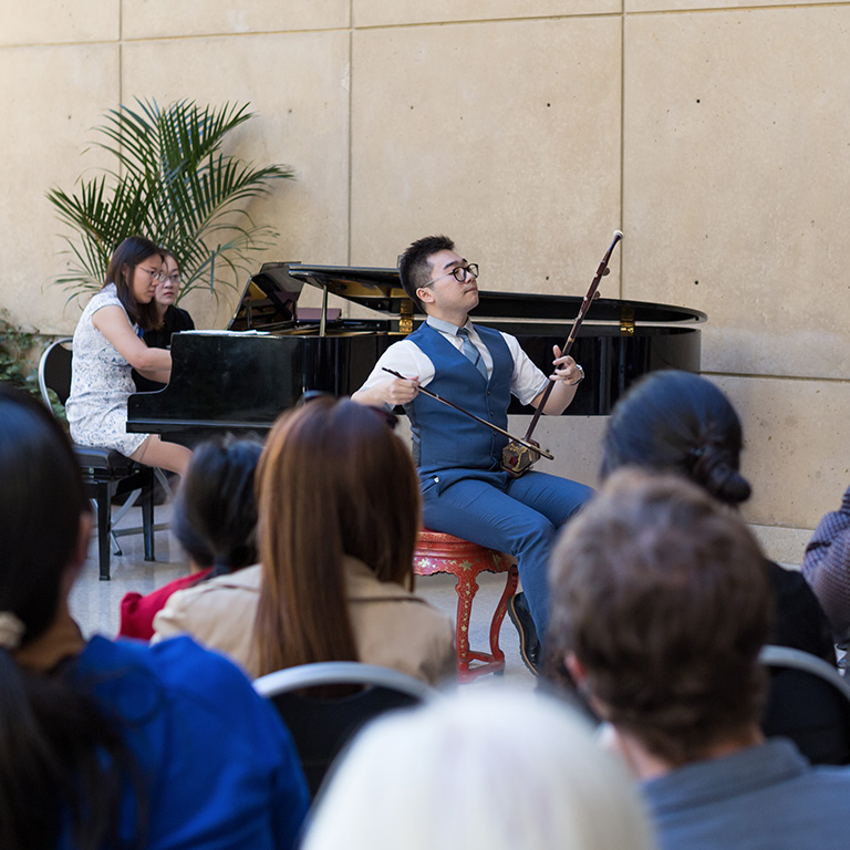 A musician plays the Erhu, a traditional Chinese violin