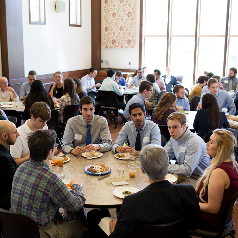 A group of people sit around a table
