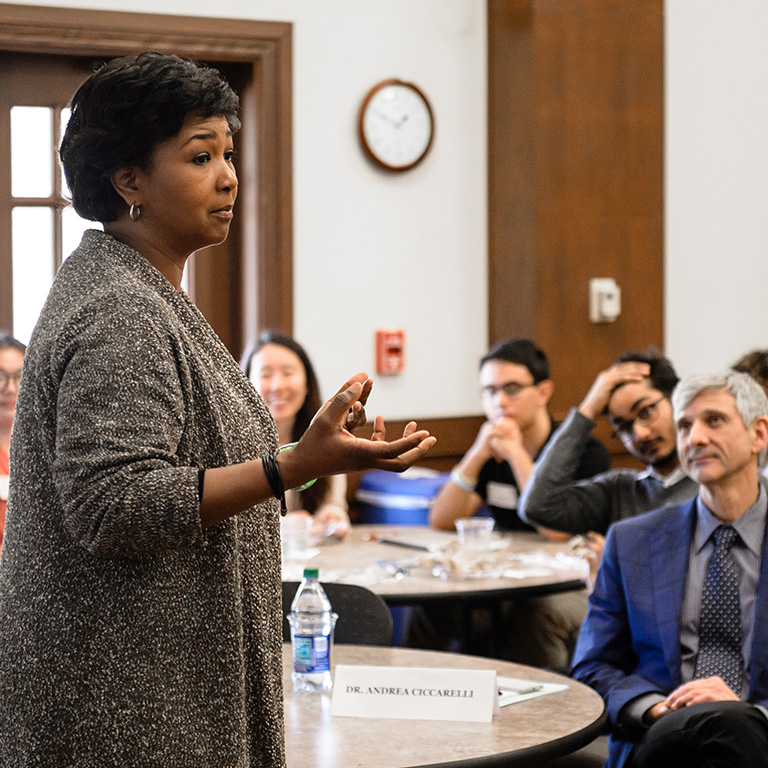 A woman speaks to an audience of people